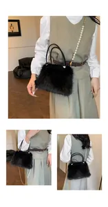 Detail of black faux fur handbag featuring pearl gold chain strap and dual leather handles
