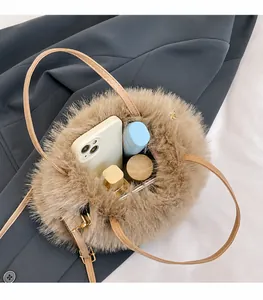 Detailed top view of fluffy faux fur handbag interior showing capacity for cosmetics and phone