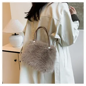 Detail of faux fox fur handbag featuring pearl accents and a golden chain strap