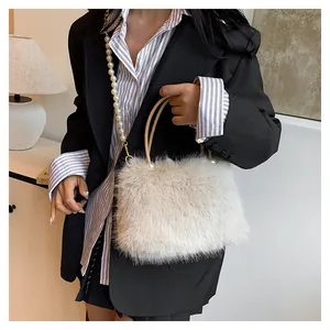 Detail of cream faux fur handbag featuring elegant pearl shoulder strap and plush texture