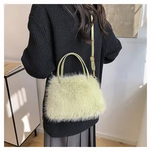 Furry plush handbag in light green with adjustable leather-style shoulder strap and top handles