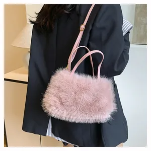 Close-up of pink faux fur crossbody bag with dual handles and adjustable leather strap