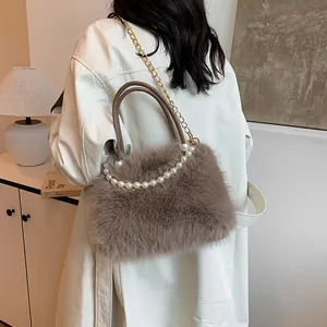 Brown faux fox fur handbag with pearl handle and gold chain strap on stylish trench coat