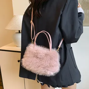 Pink faux fur handbag with leather straps worn by model in a warm indoor setting