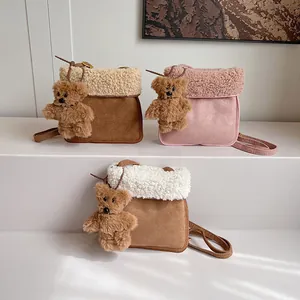 Schicke Herbst-Plüschtaschen mit Lammwollbesatz und süßen Bärenanhängern auf weißem Podest