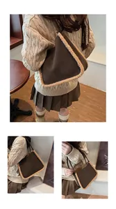 Detail of suede-like brown shoulder bag with white faux shearling trim and slim strap