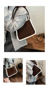 Detail of suede tote bag with white faux shearling trim and brown leather handles