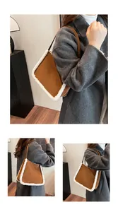 Detail of suede shoulder tote with faux shearling trim worn with a grey winter coat
