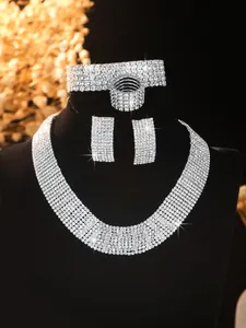 Macro view of silver bridal jewelry set with sparkling rhinestones on a velvet bust