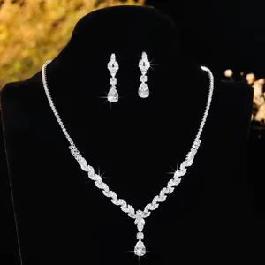 Elegant silver bridal jewelry set with zircon necklace and teardrop earrings on a black bust