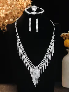 Detailed set of silver bridal jewelry with fringe necklace, earrings and bracelet