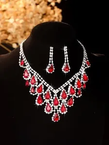 Detail of elegant bridal necklace set with sparkling red teardrop rhinestones on black velvet