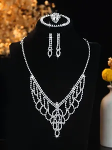 Close-up of bridal jewelry set featuring rhinestone lace necklace on a black mannequin
