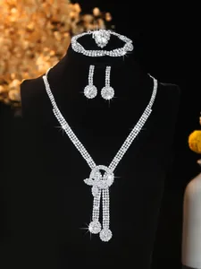 Macro detail of silver bridal jewelry set with sparkling tassels and crystal settings