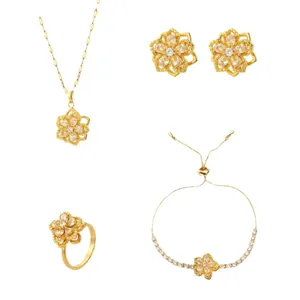 Parure de bijoux fleur dorée élégante avec collier boucles d'oreilles bague et bracelet