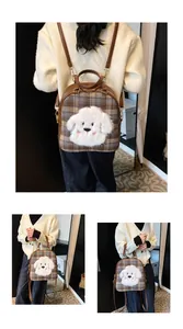 Detail view of brown plaid handbag with cute plush dog patch and golden buckles