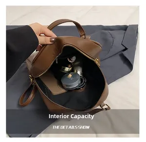 Close-up of brown plaid tote bag internal capacity with cosmetics and smartphone
