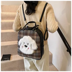 Detail of cute plaid backpack with plush puppy patch and adjustable leather straps