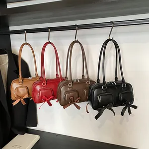 Minimalist vintage shoulder bags in camel, red, brown, and black with bow details