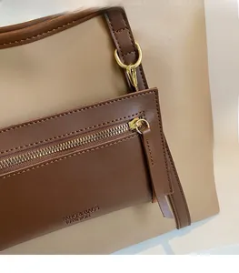 Detailaufnahme der Khaki-Leder-Einkaufstasche mit Gold-Reißverschluss und Naht