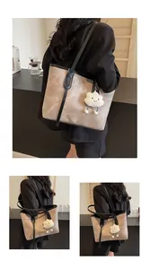 Detail of the minimalist tote bag with chic cloud charm and contrasting black straps