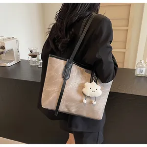 Brown marble-textured large tote bag with a white cloud charm shown on a shoulder