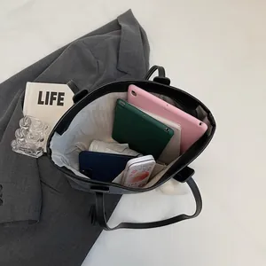 Large black PU leather tote bag showing spacious interior for tablets and daily essentials