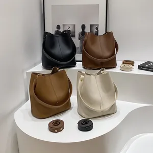 Classic leather bucket bag in four neutral colors featuring lychee pattern and wide strap