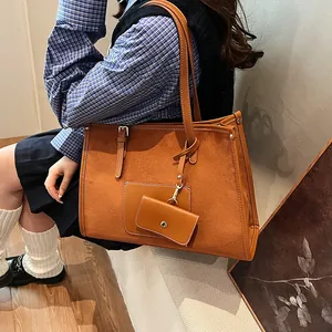 Brown suede tote bag with smooth leather trim and matching small pouch for commuting