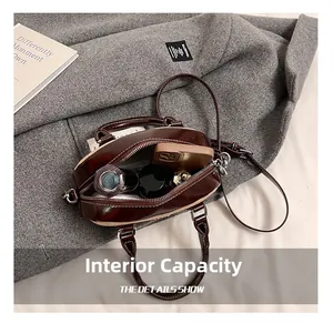 Detail showing the internal capacity of the two-tone bowling bag with personal essentials