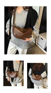 Detail view of brown faux leather half-moon bag featuring textured finish and charm