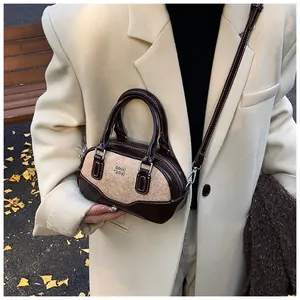 Detail of vintage bowling bag with bicolor stitching and fine leather texture