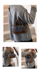 Detail of vintage denim bowling bag with leather handles and crossbody strap