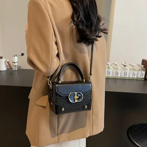 Chic black crocodile embossed box handbag with gold hardware and top handle for women