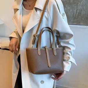 Brown lychee grain leather tote bag shown in handheld and crossbody styles for women