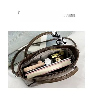 Interior view of brown leather bucket bag showing large capacity for daily essentials