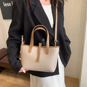 Litchi texture beige tote bag with brown leather handles and adjustable shoulder strap