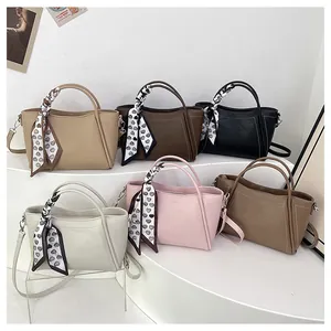 Assorted colors of textured leather bucket bags with heart pattern scarf wrap handles