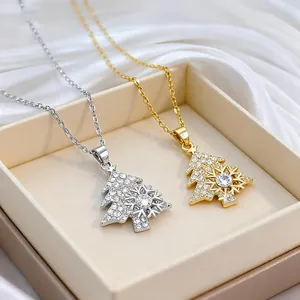 Rotating snowflake Christmas tree necklace in gold and silver with sparkling crystals