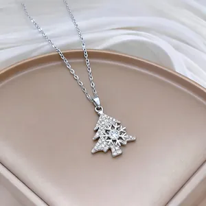 Macro shot of silver rotating snowflake Christmas tree necklace with sparkling zirconia