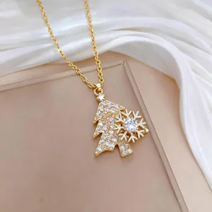 Close-up of a golden rotating snowflake and rhinestone-encrusted Christmas tree necklace