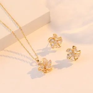 Goldenes rotierendes Windrad-Schmuckset mit Halskette und funkelnden Zirkonia