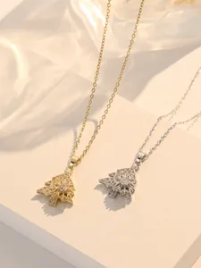 Close-up of rotatable Christmas tree and snowflake pendants in gold and silver finishes