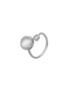Detailed close-up of a silver bypass ring featuring a large cat's eye stone and zircon
