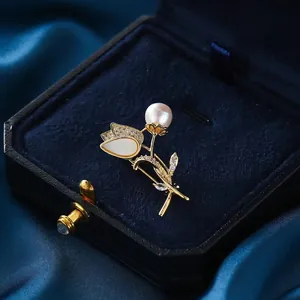 Elegant gold tulip brooch with pearl and zircon inlay on premium blue velvet box