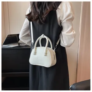 Chic white leather shoulder bag with twisted handle knots and silver hardware details