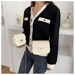 Detail comparison of large and small white quilted chain bags with gold metal locks