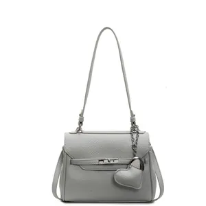 Litchi pattern light grey Kelly style handbag with a cute heart pendant and top handle