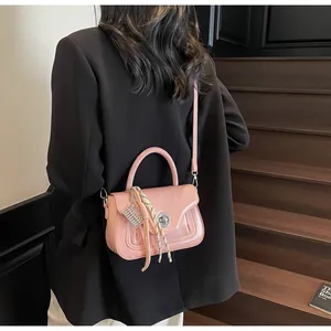 Pink oily leather mini bag with chain strap and silk scarf detail shown on model