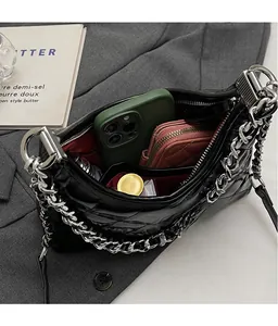 Quilted black chain bag interior showcasing spacious storage for phone and wallet